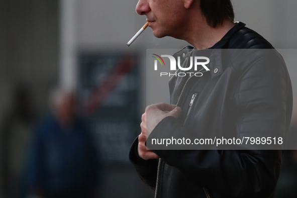 A man smokes a cigarette in Krakow, Poland on March 28, 2022. 