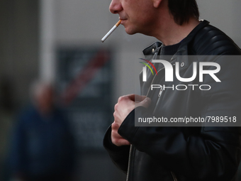 A man smokes a cigarette in Krakow, Poland on March 28, 2022. (