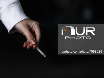 A woman smokes a cigarette in Krakow, Poland on March 28, 2022. (