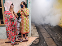 Health officials in the field of public environment carry out fumigation of the environment on residents in Grinding, Jakarta on March 29, 2...