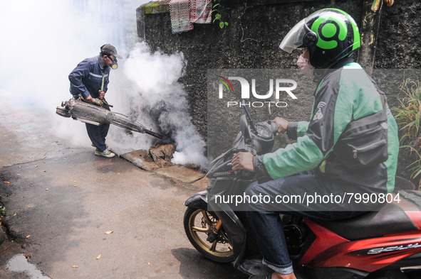 Health officials in the field of public environment carry out fumigation of the environment on residents in Grinding, Jakarta on March 29, 2...