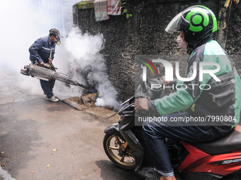 Health officials in the field of public environment carry out fumigation of the environment on residents in Grinding, Jakarta on March 29, 2...