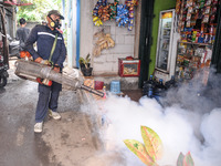 Health officials in the field of public environment carry out fumigation of the environment on residents in Grinding, Jakarta on March 29, 2...