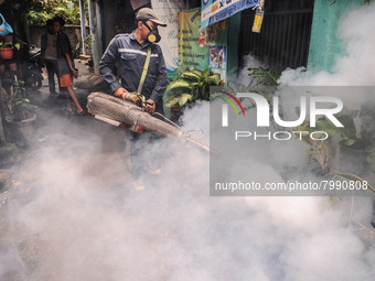 Health officials in the field of public environment carry out fumigation of the environment on residents in Grinding, Jakarta on March 29, 2...