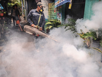 Health officials in the field of public environment carry out fumigation of the environment on residents in Grinding, Jakarta on March 29, 2...