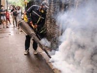 Health officials in the field of public environment carry out fumigation of the environment on residents in Grinding, Jakarta on March 29, 2...