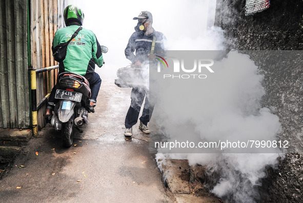 Health officials in the field of public environment carry out fumigation of the environment on residents in Grinding, Jakarta on March 29, 2...