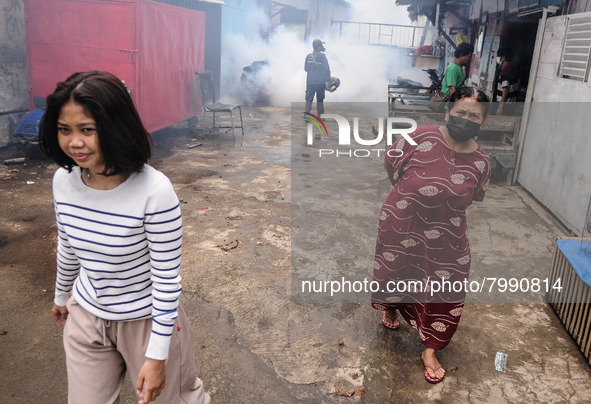 Health officials in the field of public environment carry out fumigation of the environment on residents in Grinding, Jakarta on March 29, 2...