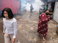 Health officials in the field of public environment carry out fumigation of the environment on residents in Grinding, Jakarta on March 29, 2...