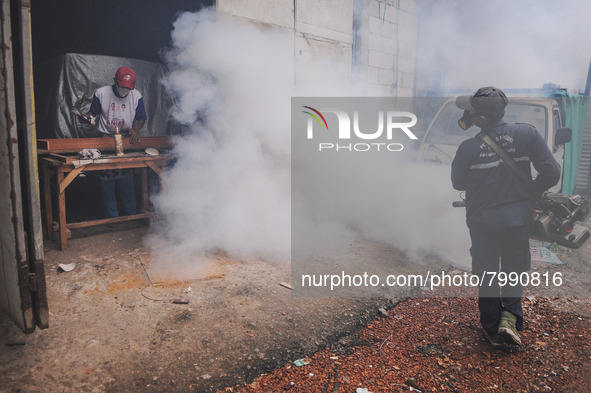 Health officials in the field of public environment carry out fumigation of the environment on residents in Grinding, Jakarta on March 29, 2...