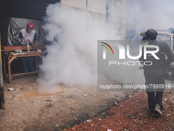 Health officials in the field of public environment carry out fumigation of the environment on residents in Grinding, Jakarta on March 29, 2...