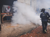 Health officials in the field of public environment carry out fumigation of the environment on residents in Grinding, Jakarta on March 29, 2...