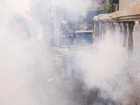 Health officials in the field of public environment carry out fumigation of the environment on residents in Grinding, Jakarta on March 29, 2...