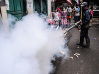 Health officials in the field of public environment carry out fumigation of the environment on residents in Grinding, Jakarta on March 29, 2...