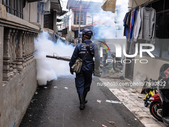 Health officials in the field of public environment carry out fumigation of the environment on residents in Grinding, Jakarta on March 29, 2...