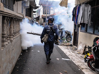 Health officials in the field of public environment carry out fumigation of the environment on residents in Grinding, Jakarta on March 29, 2...