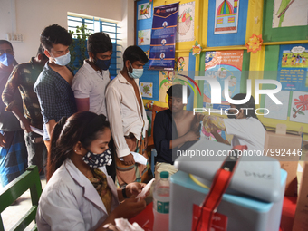 Slum dwellers receive a dose of COVID-19 vaccine at a makeshift vaccination center at Karail Slum in Dhaka, Bangladesh, on March 29, 2022...