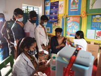 Slum dwellers receive a dose of COVID-19 vaccine at a makeshift vaccination center at Karail Slum in Dhaka, Bangladesh, on March 29, 2022...