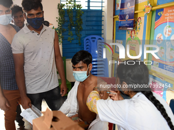 Slum dwellers receive a dose of COVID-19 vaccine at a makeshift vaccination center at Karail Slum in Dhaka, Bangladesh, on March 29, 2022...