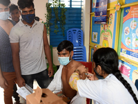 Slum dwellers receive a dose of COVID-19 vaccine at a makeshift vaccination center at Karail Slum in Dhaka, Bangladesh, on March 29, 2022...