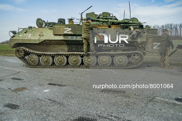 Ukrainian soldiers repair captured armored vehicles with the symbol Z of the russian army during the combats in Kharkiv, Ukraine. 