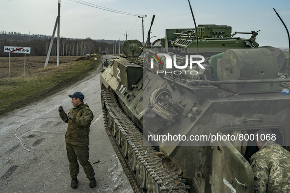 Ukrainian soldiers in a captured armored vehicle of the russian army during the combats in Kharkiv, Ukraine. 