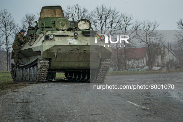 Ukrainian soldier checks a captured armored vehicle with the symbol Z of the russian army after the combats in Kharkiv, Ukraine. 