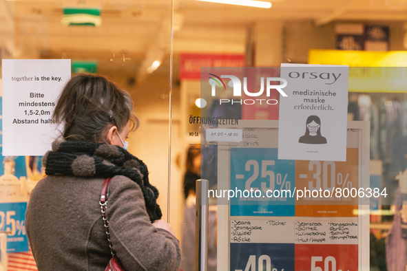 a retailer store with mask sign is seen in city center of Bonn, Germany on April 2, 2022 as many rules of covid 19 will be expired this week...