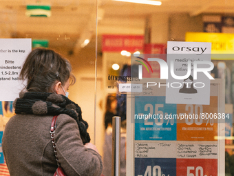 a retailer store with mask sign is seen in city center of Bonn, Germany on April 2, 2022 as many rules of covid 19 will be expired this week...