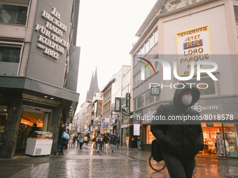 a shopper walks with face mask in the city center of Cologne, Germany on April 4, 2022 after Germany lifts majority of covid 19 restrictions...