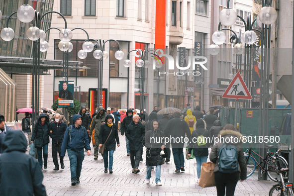 Shoppers are seen without face mask walking in the city center of Cologne, Germany on April 4, 2022 after Germany lifts majority of covid 19...