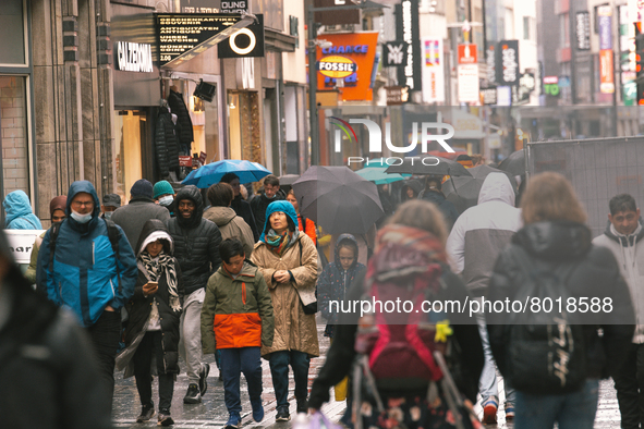 Shoppers are seen without face mask walking in the city center of Cologne, Germany on April 4, 2022 after Germany lifts majority of covid 19...