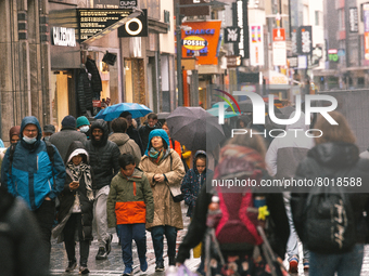 Shoppers are seen without face mask walking in the city center of Cologne, Germany on April 4, 2022 after Germany lifts majority of covid 19...