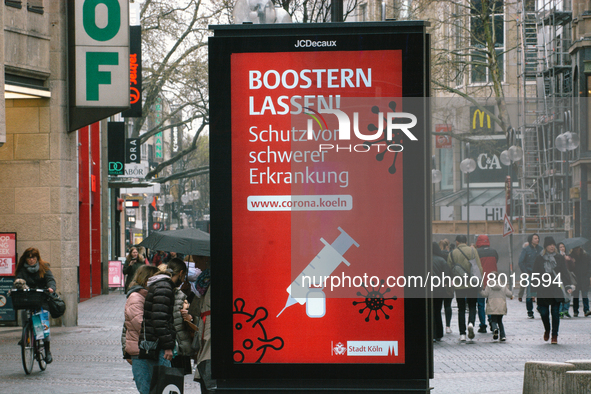 public information ad is seen to suggest people to " take a boost vaccine"  n the city center of Cologne, Germany on April 4, 2022 after Ger...