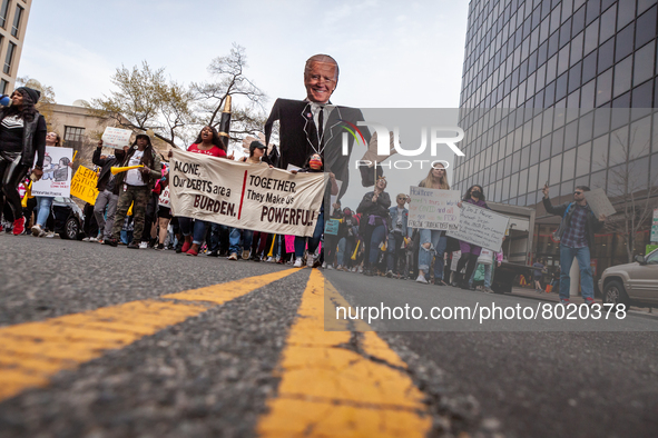 Students march around the Department of Education during event demanding student debt cancellation.  Hundreds of tudents took part in a day...