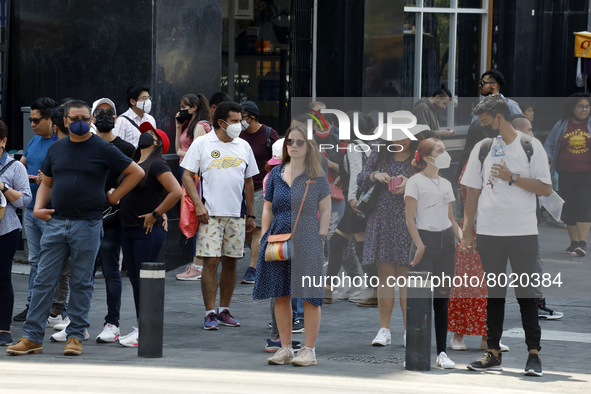 People take to the streets of the Mexico City downtown without wearing face masks, after the Government softened the measures due to the epi...