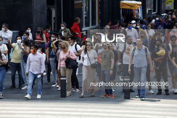 People take to the streets of the Mexico City downtown without wearing face masks, after the Government softened the measures due to the epi...