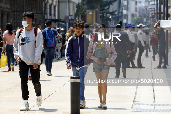 People take to the streets of the Mexico City downtown without wearing face masks, after the Government softened the measures due to the epi...