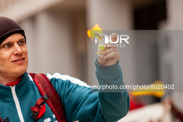 A student sets fire to a small piece of paper symbolizing his student debt during a rally to cancel all education debt at the Department of...