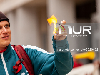 A student sets fire to a small piece of paper symbolizing his student debt during a rally to cancel all education debt at the Department of...