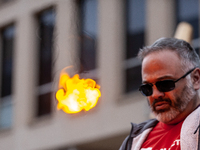 A 50-year-old man with debt as a result of going to college later in life, sets fire to a small piece of paper symbolizing his student debt...