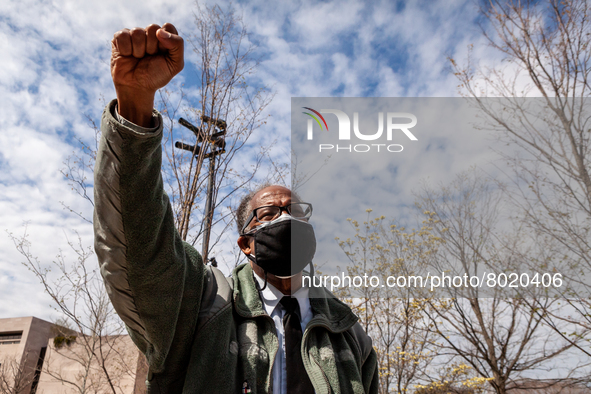 Irving Jones raises his fist in solidarity with students rallying to cancel their educational debt at the Department of Education.  Jones is...