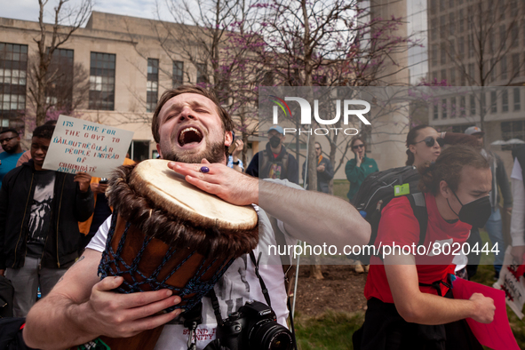 A protester joyously plays a drum at a rally to cancel student debt at the Department of Education.  Students took part in a day of action u...