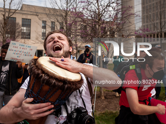 A protester joyously plays a drum at a rally to cancel student debt at the Department of Education.  Students took part in a day of action u...