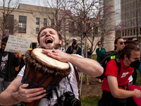 A protester joyously plays a drum at a rally to cancel student debt at the Department of Education.  Students took part in a day of action u...