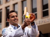 A student sets fire to a small piece of paper symbolizing his student debt during a rally to cancel all education debt at the Department of...