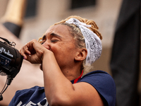 A protester chokes up while speaking about the harmful effects student debt has had on her life during a rally to cancel educational debt at...