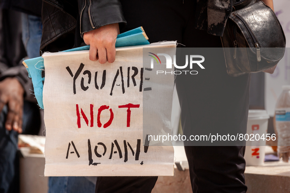 A protester carries a sign sayting that "you are not a loan," during a rally to cancel student debt at the Department of Education.  Student...