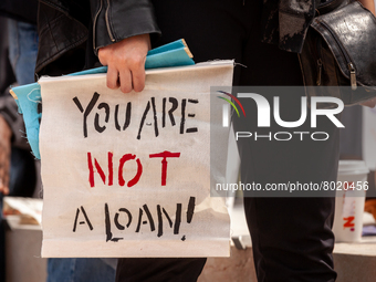 A protester carries a sign sayting that "you are not a loan," during a rally to cancel student debt at the Department of Education.  Student...