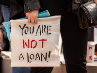 A protester carries a sign sayting that "you are not a loan," during a rally to cancel student debt at the Department of Education.  Student...